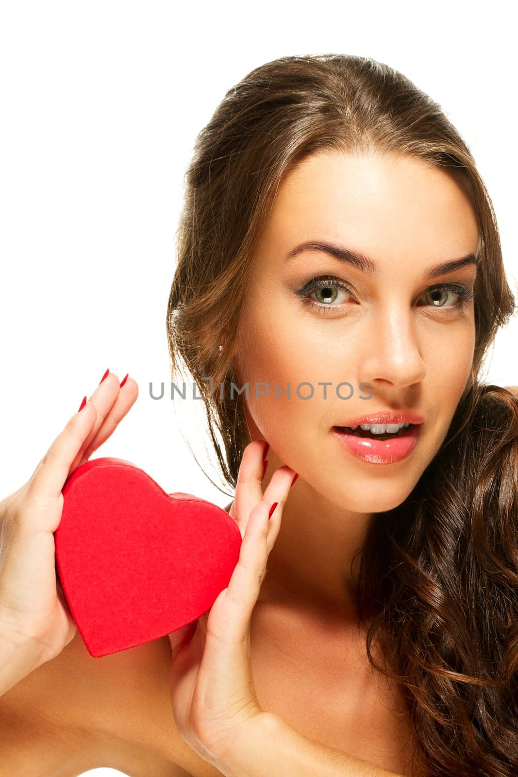 Beautiful brunette woman showing red heart against white background