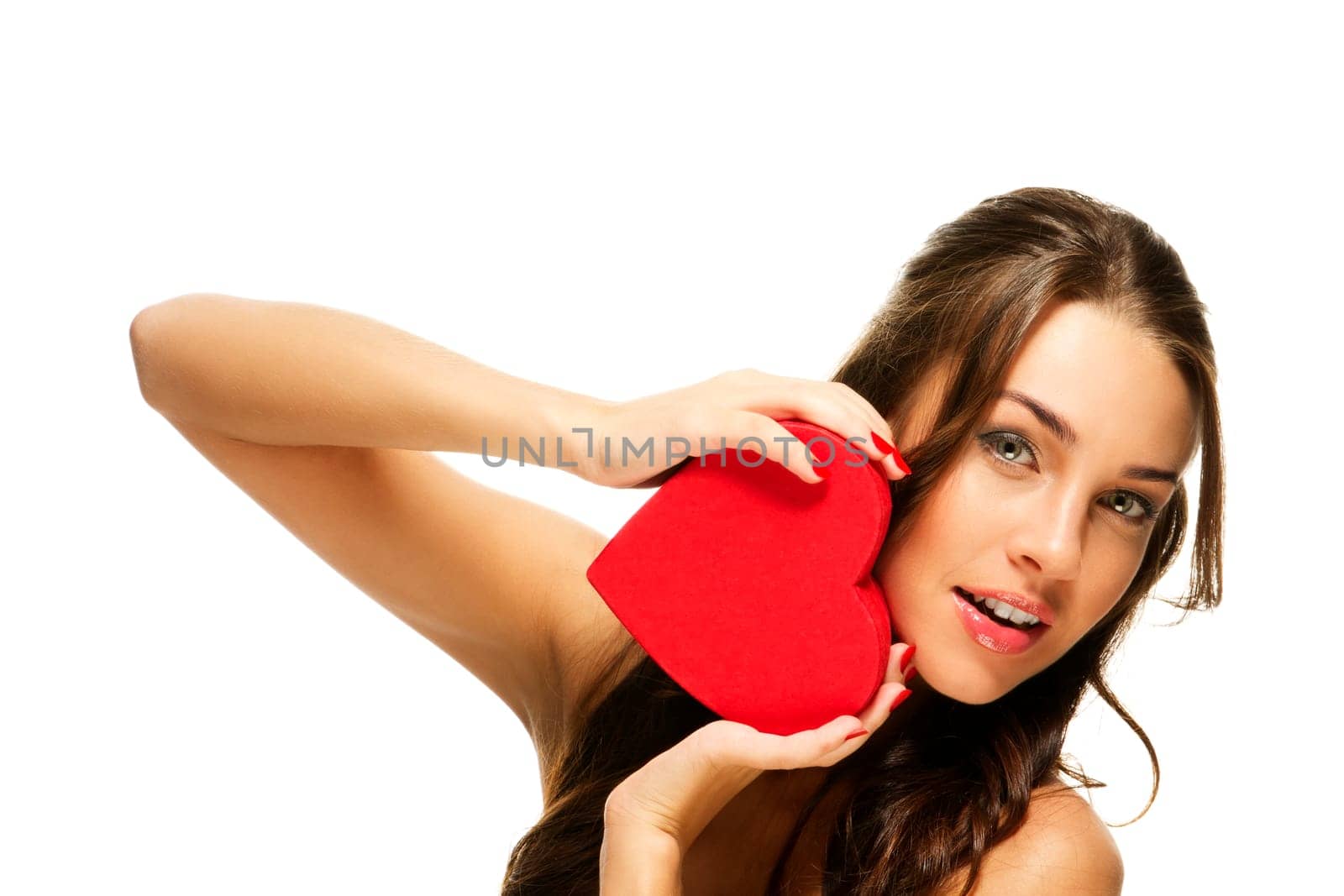 Beautiful woman holding red heart against white background