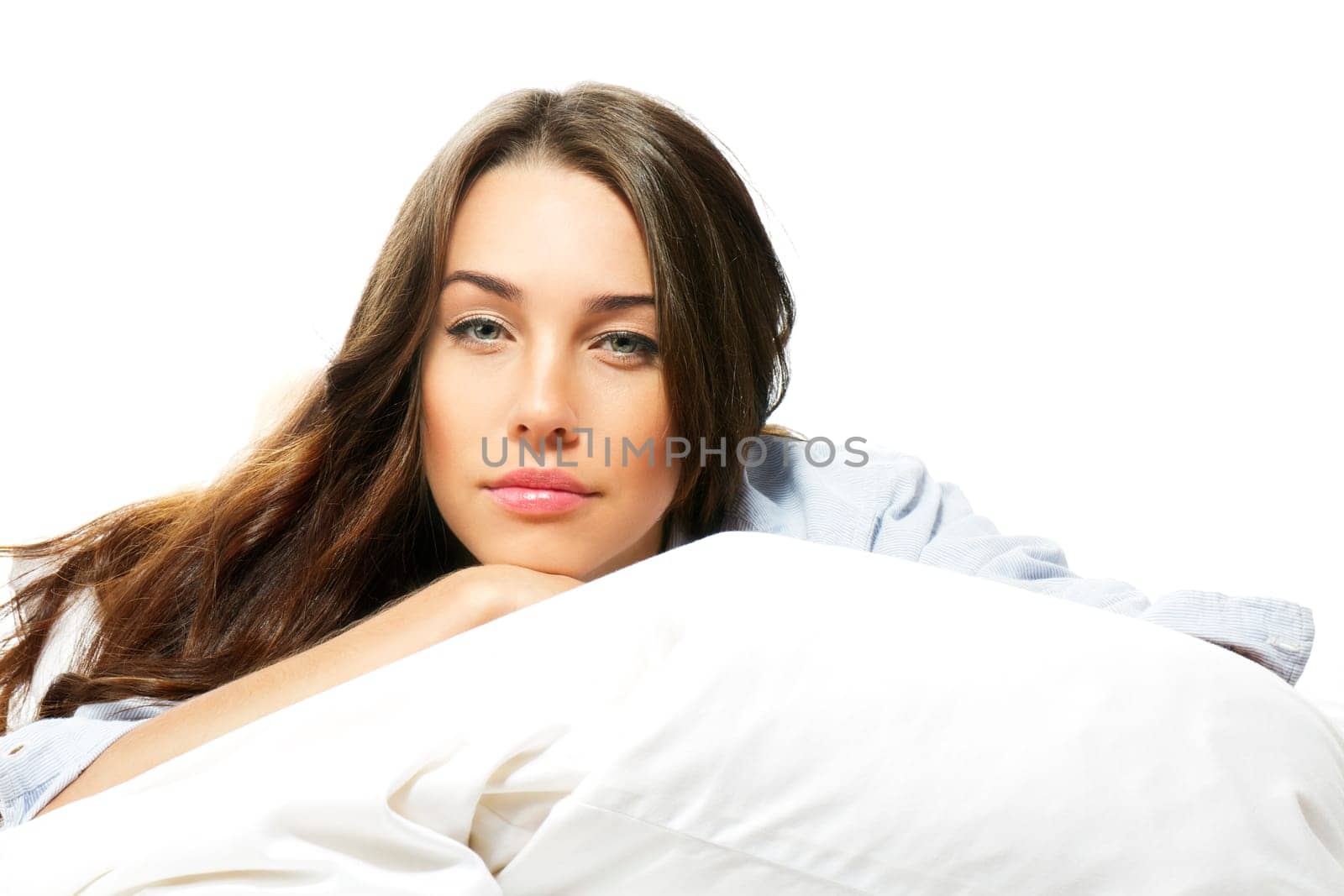 Portrait of a beautiful woman in bed against white background
