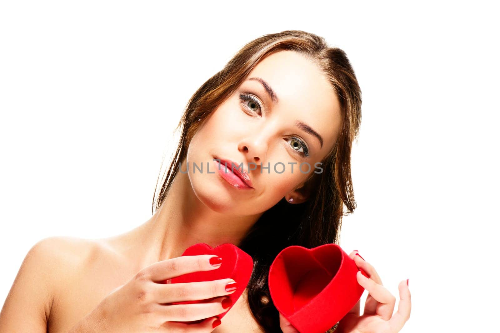 Beautiful woman opening heart-shaped box against white background