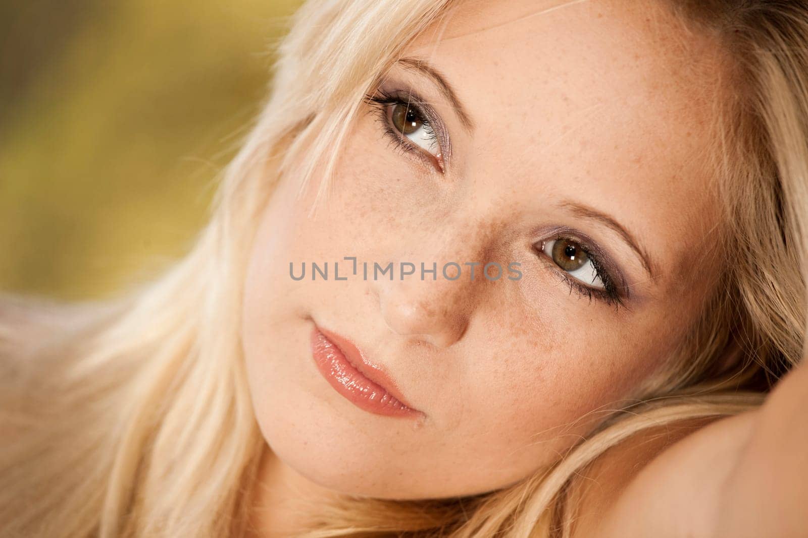 Outdoor portrait of a beautiful young woman thinking on something