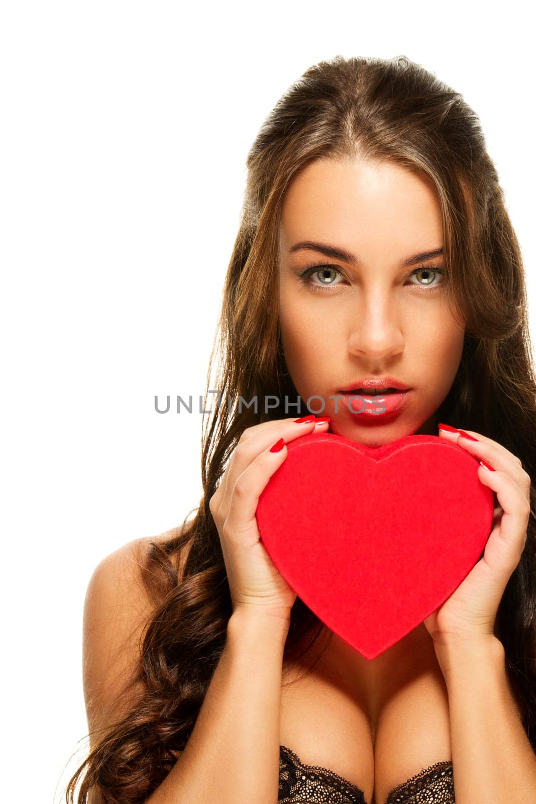 Beautiful woman holding red heart against white background