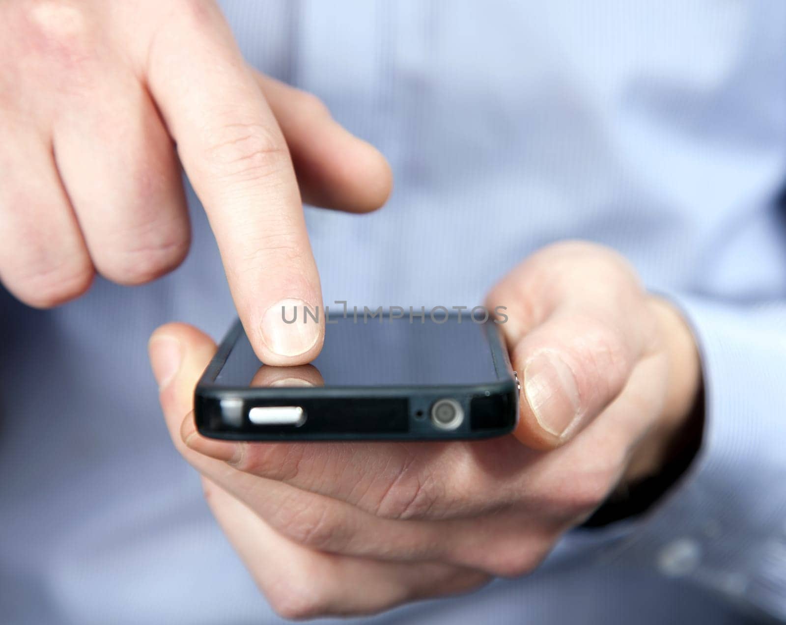 Hands of a man using a smartphone