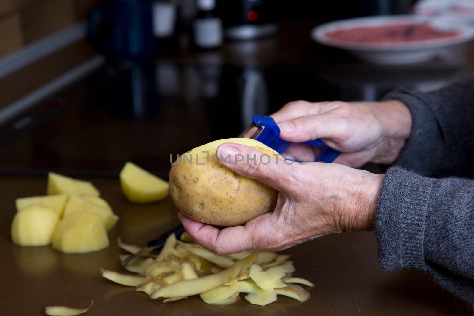 Woman peels potatoes
