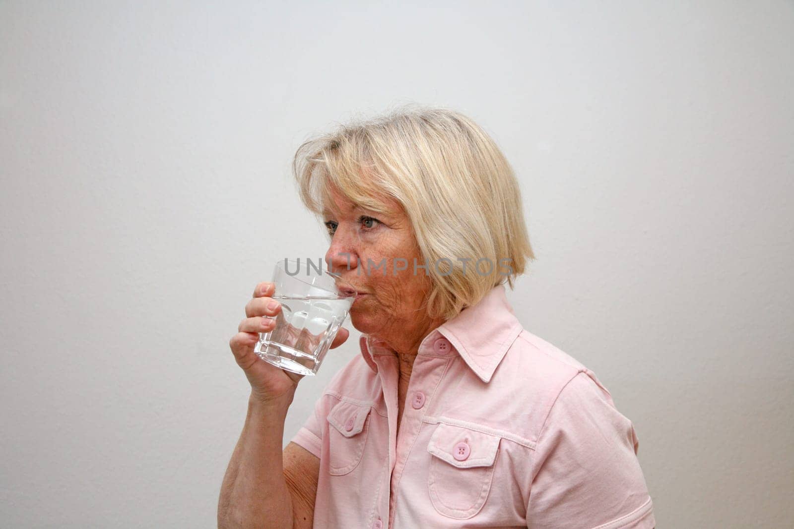 Senior woman with glass of water