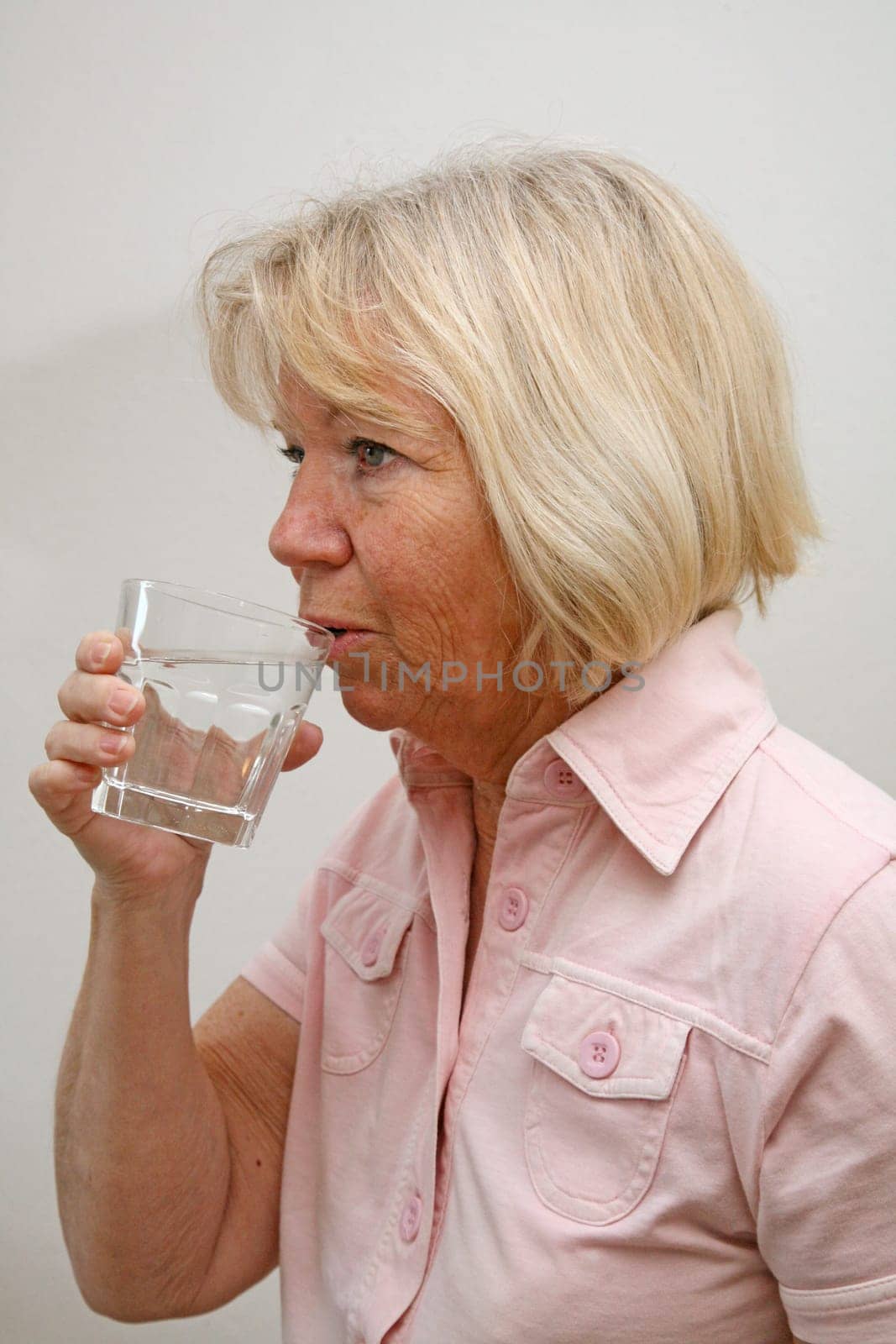 Senior woman with glass of water