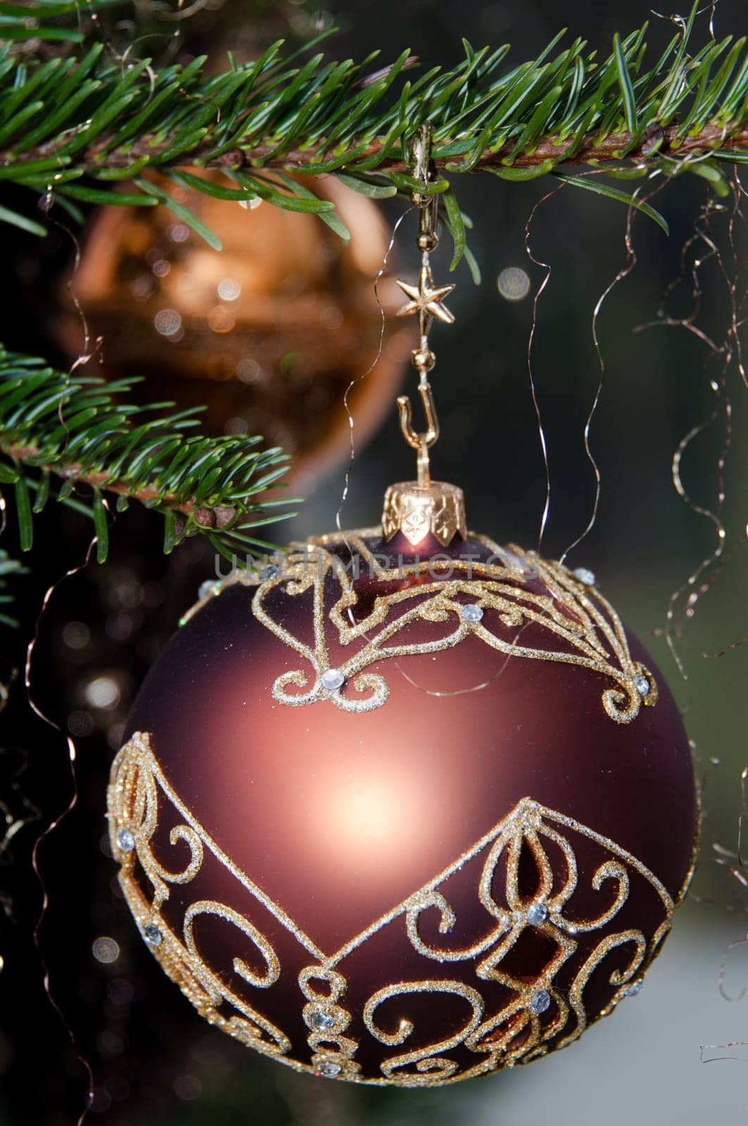 Decorative Christmas balls hanging on pine - tree branch