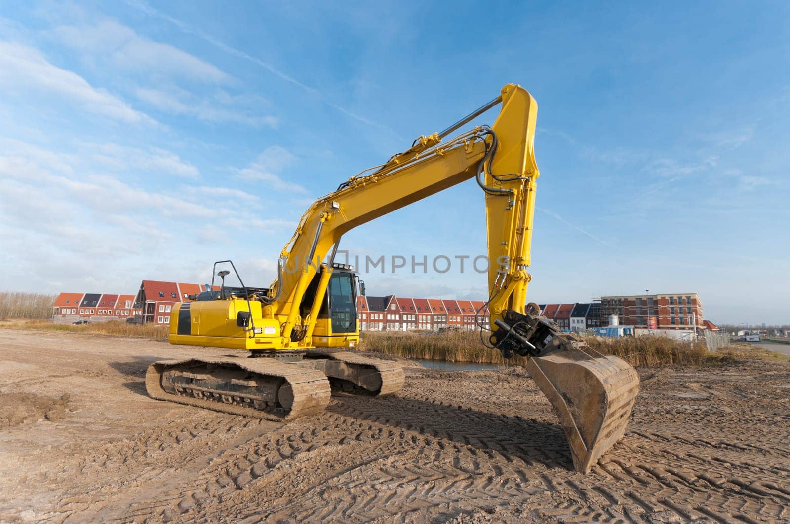 excavator in front of a newly build residential area