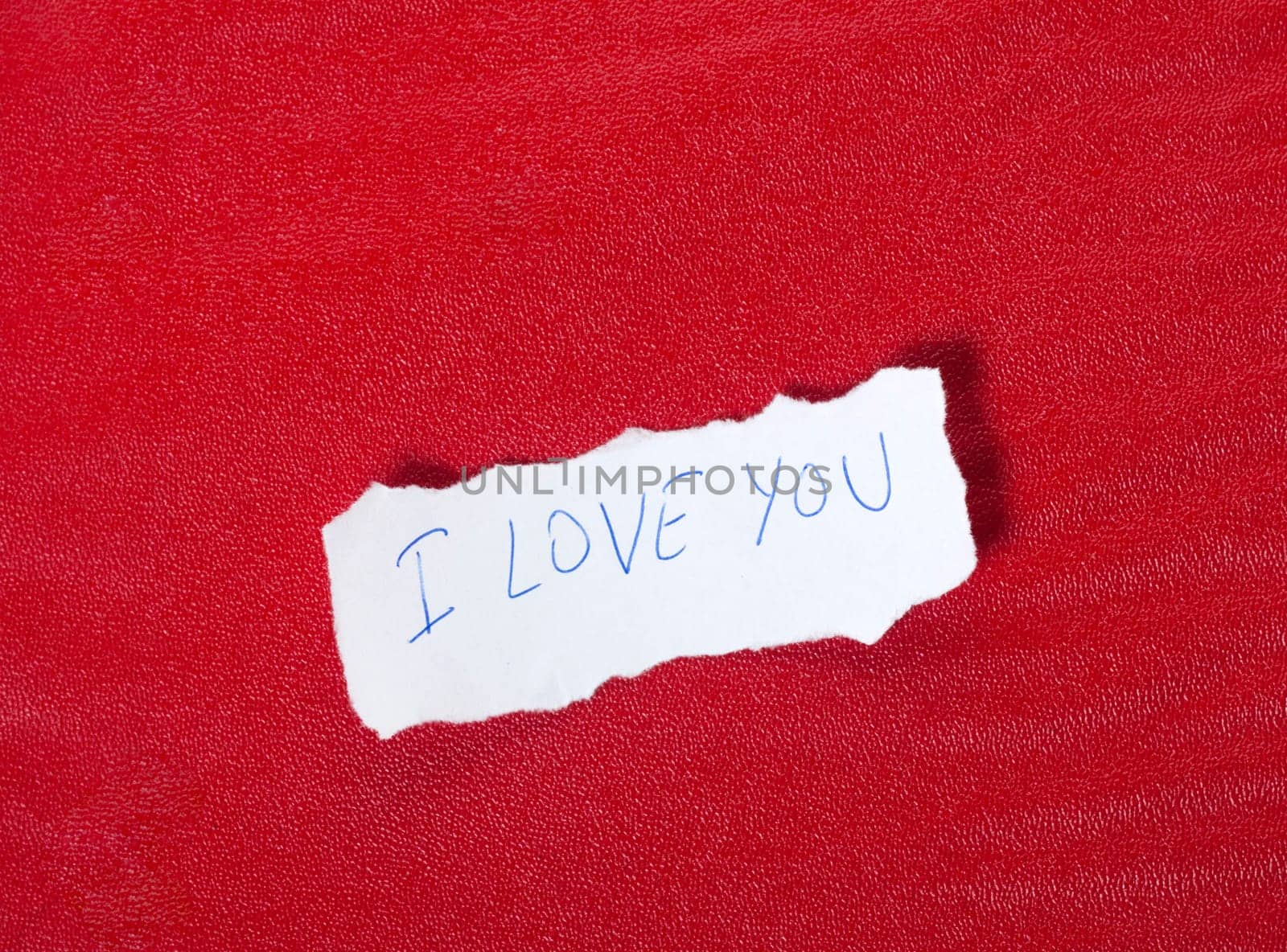 Ripped paper on red background with message of love