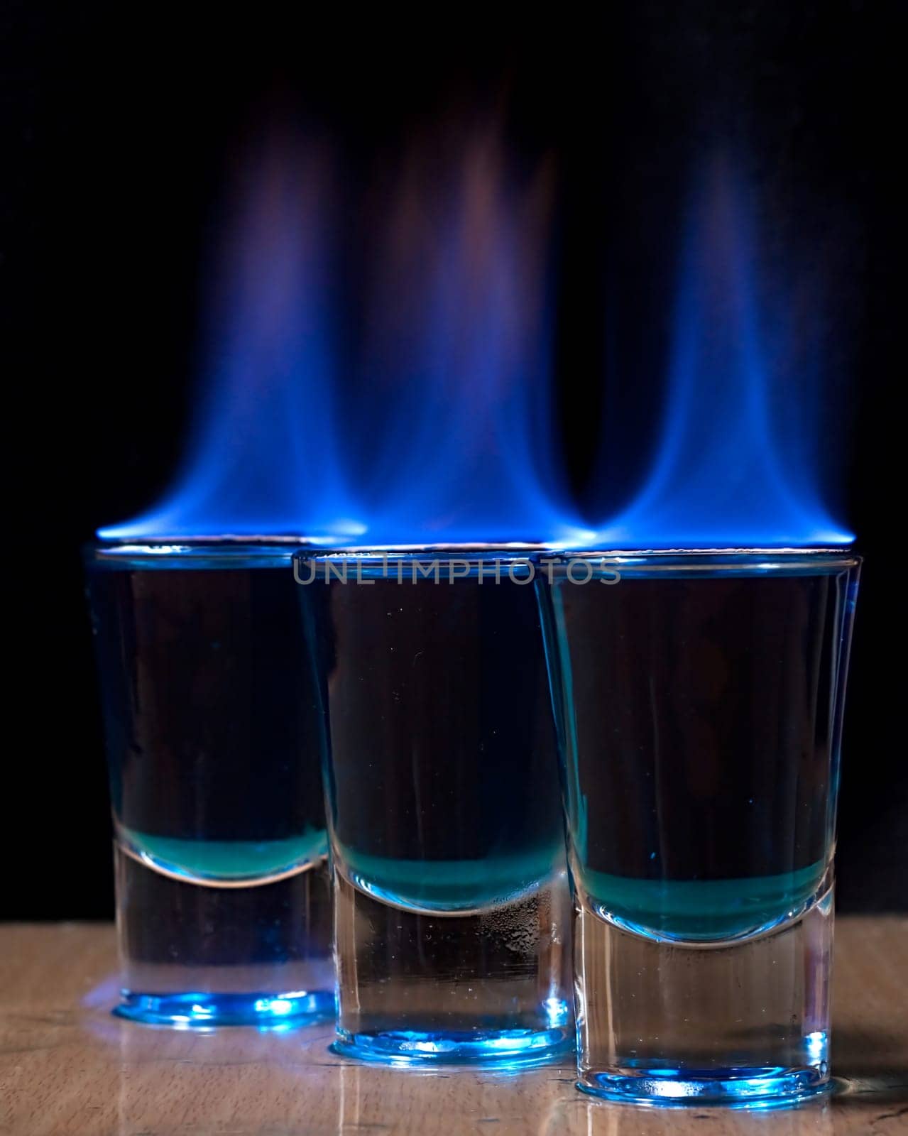 Burning drink in shot glass on a table