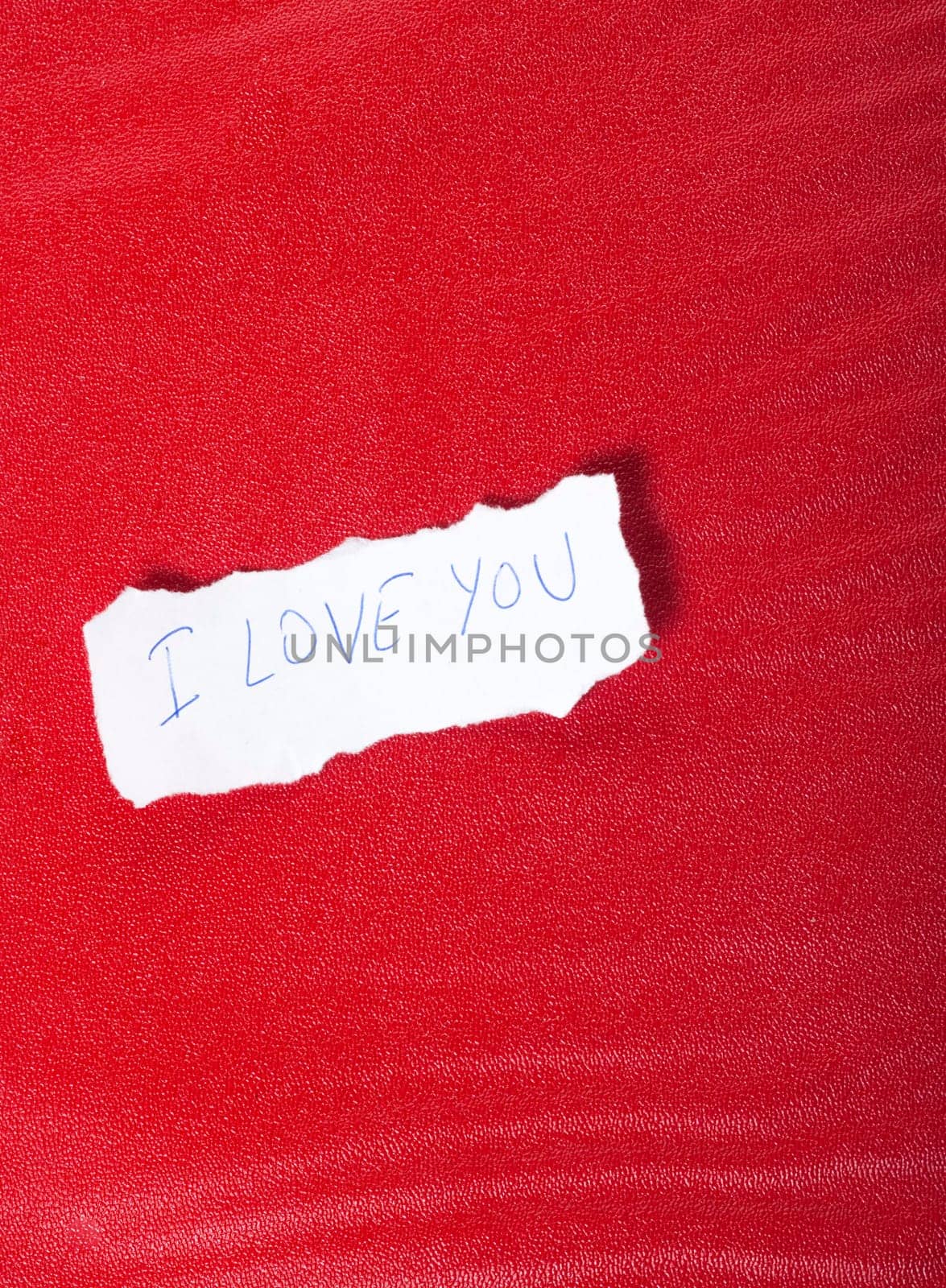 Ripped paper on red background with message of love