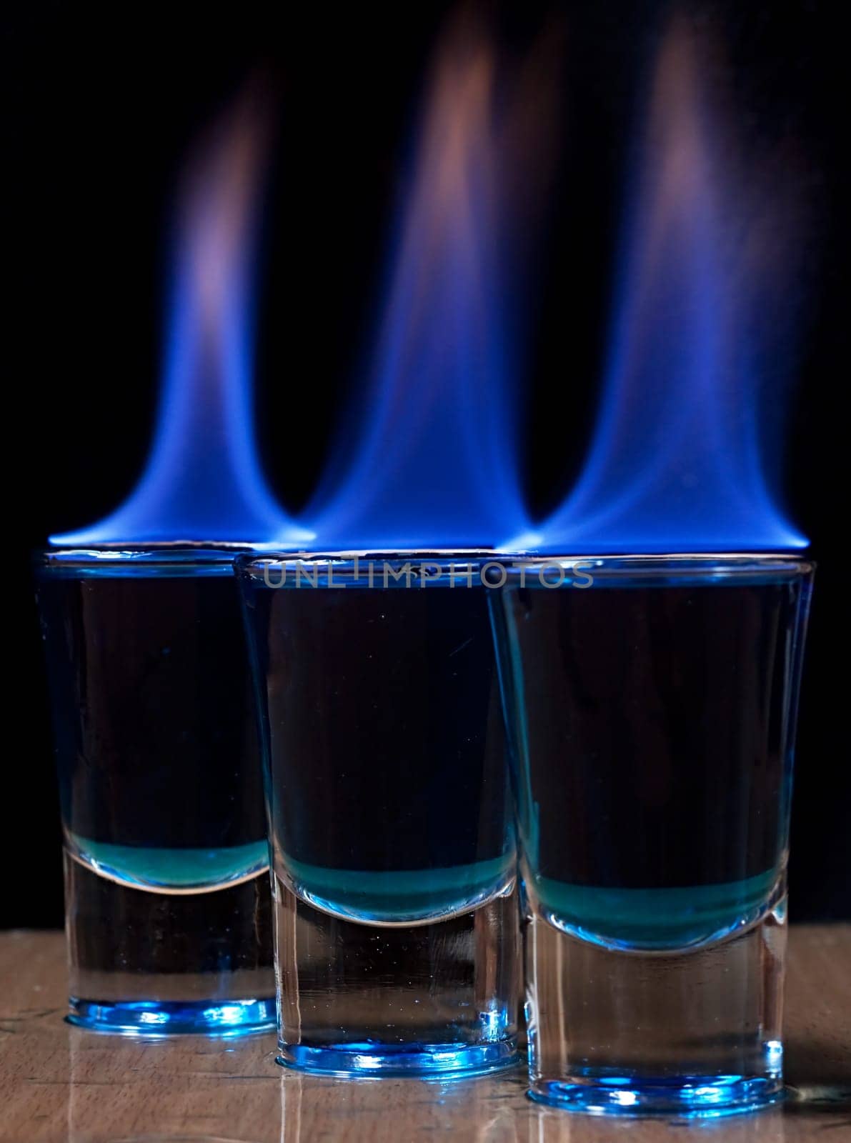 Burning drink in shot glass on a table