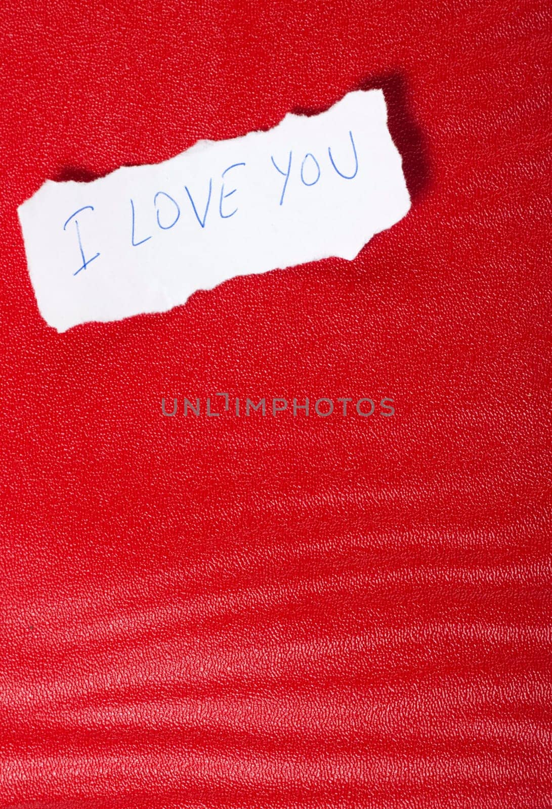 Ripped paper on red background with message of love
