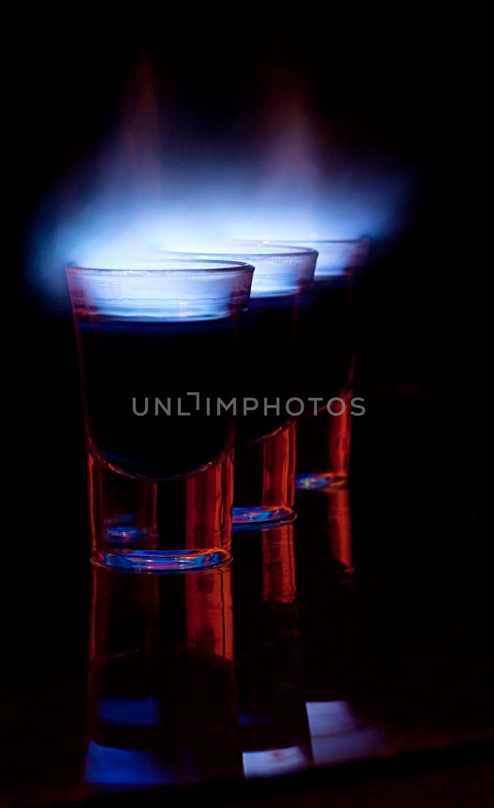 Burning drink in shot glass on a table