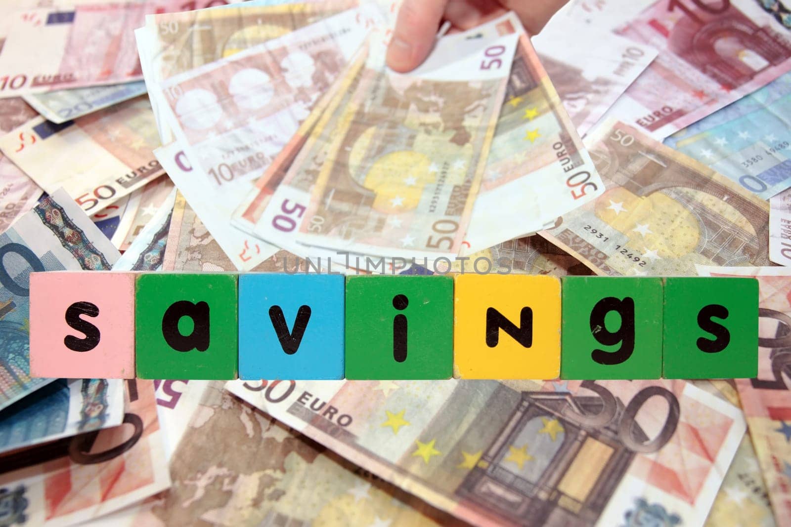 toy letters that savings against a money background with clipping path