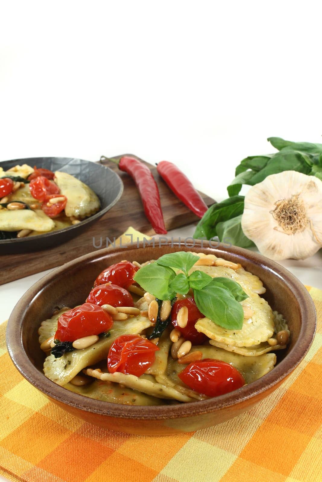 Cappelletti with melted tomatoes and roasted pine nuts