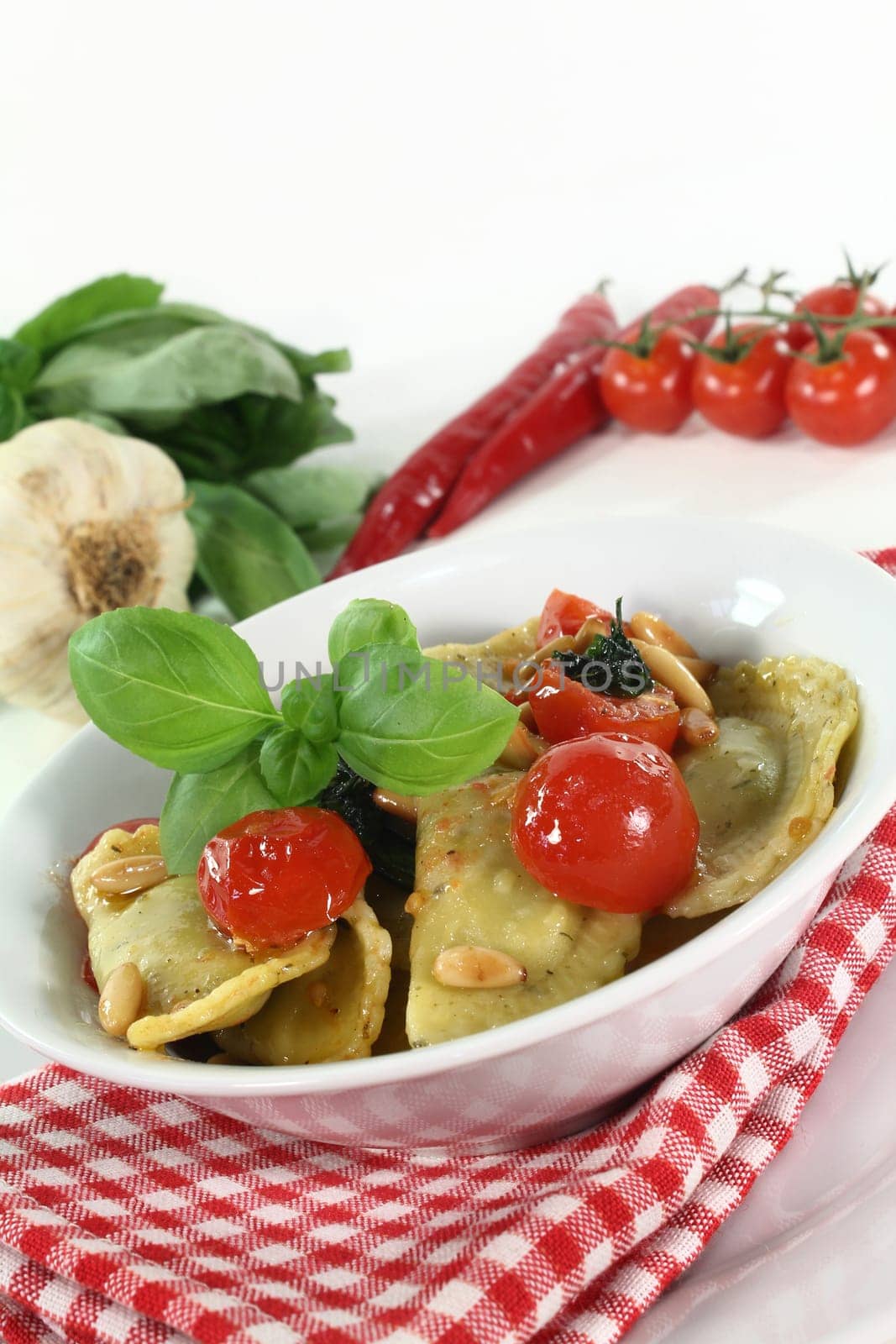 Cappelletti with melted tomatoes and roasted pine nuts