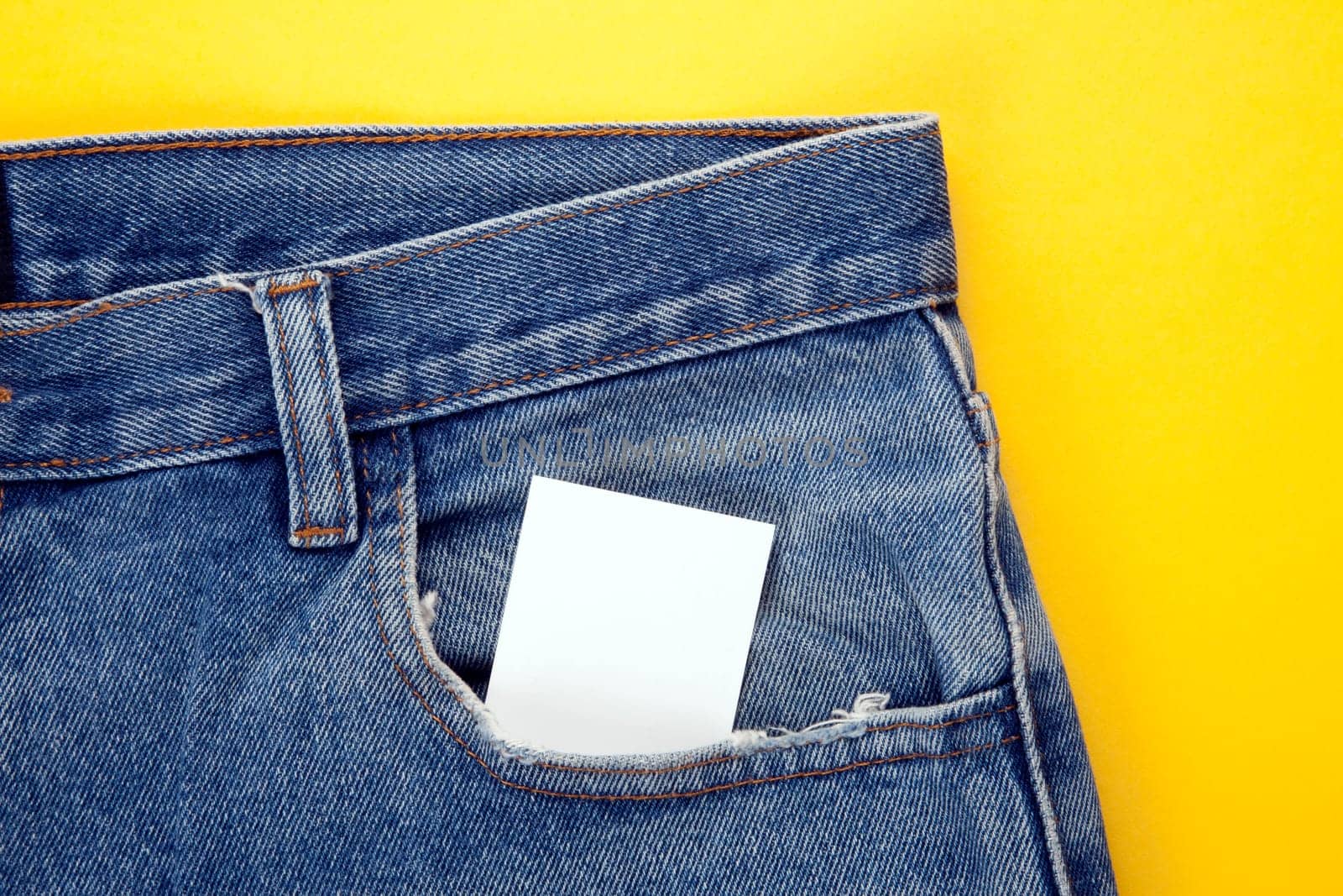 blank paper in the jeans pocket with yellow backgraund