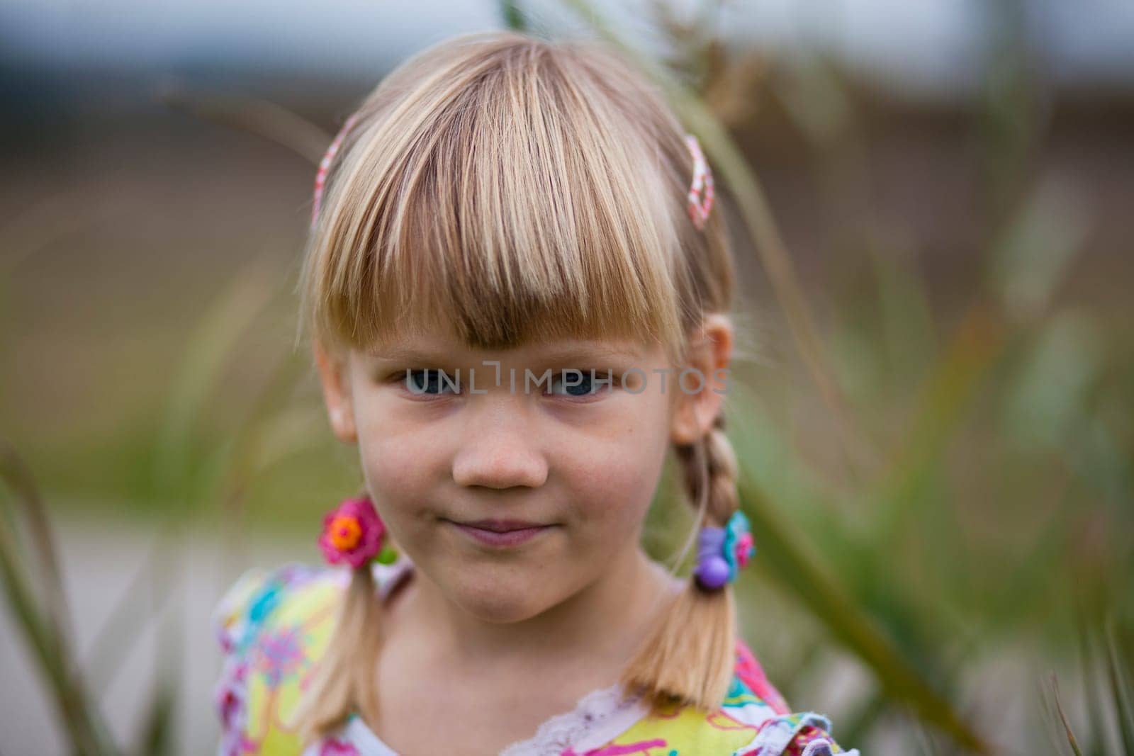 Portrait of a cute little girl outdoors on a spring day