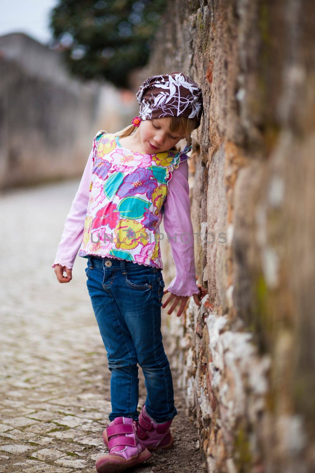 Portrait of a little girl outdoors on a city street
