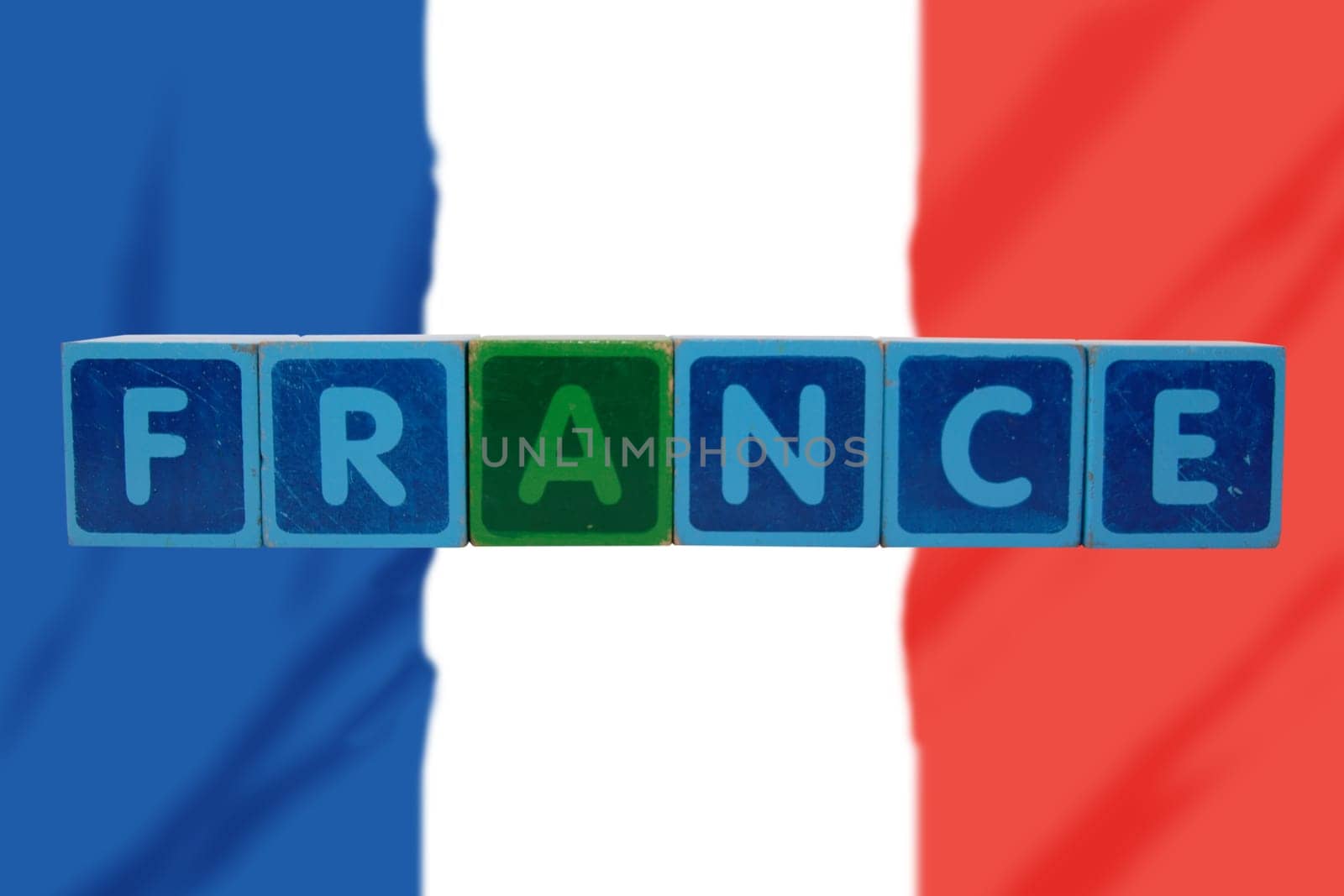 toy letters that spell france against a flag background with clipping path