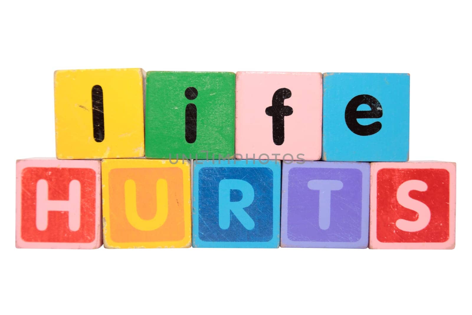 toy letters that spell life hurts against a white background with clipping path