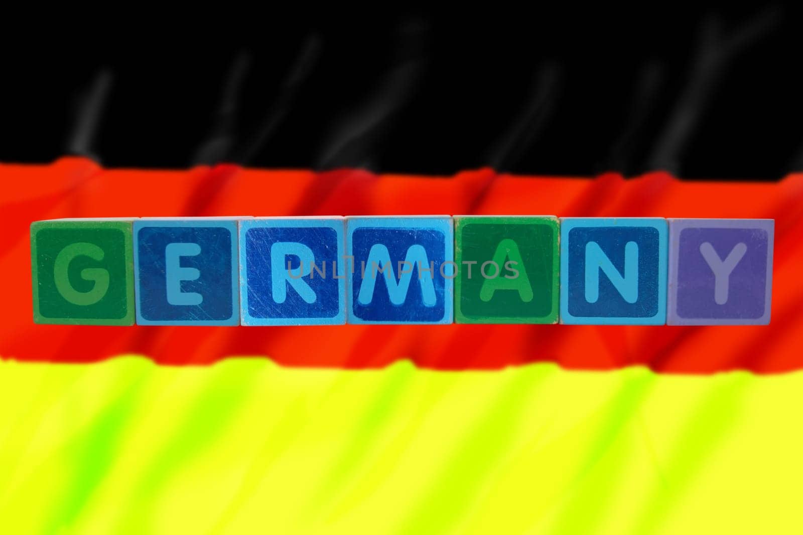 toy letters that spell germany against a flag background with clipping path
