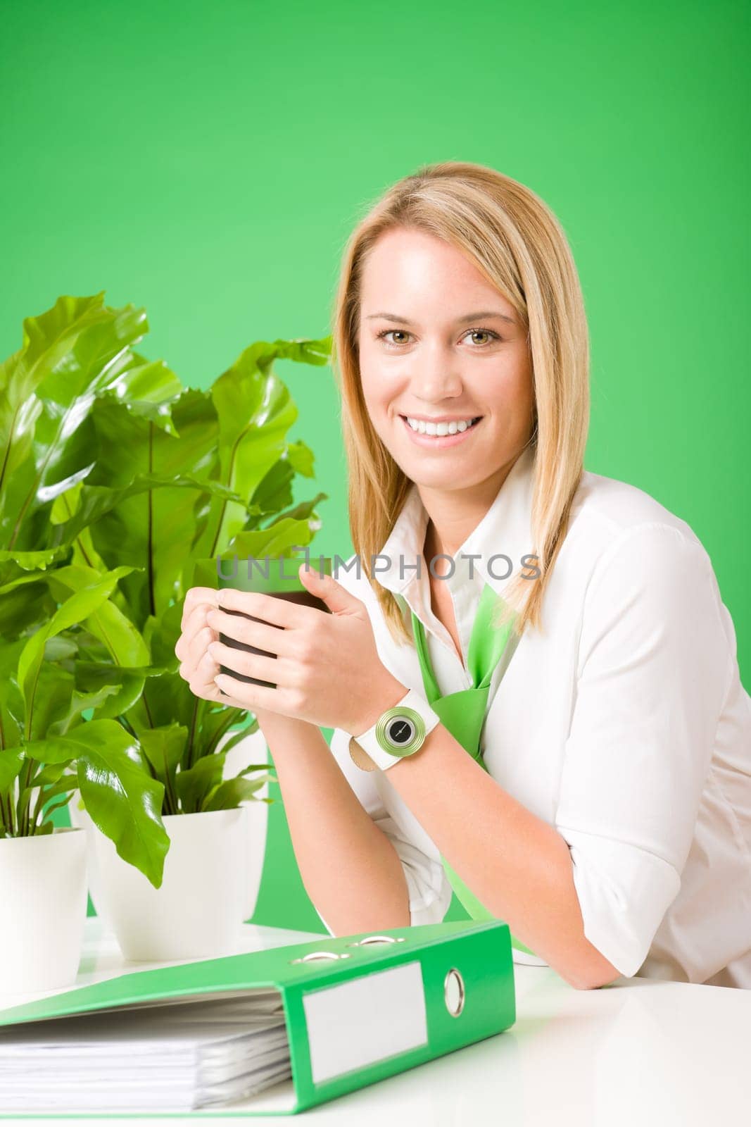 Green business woman in office drink coffee plant environment friendly smile