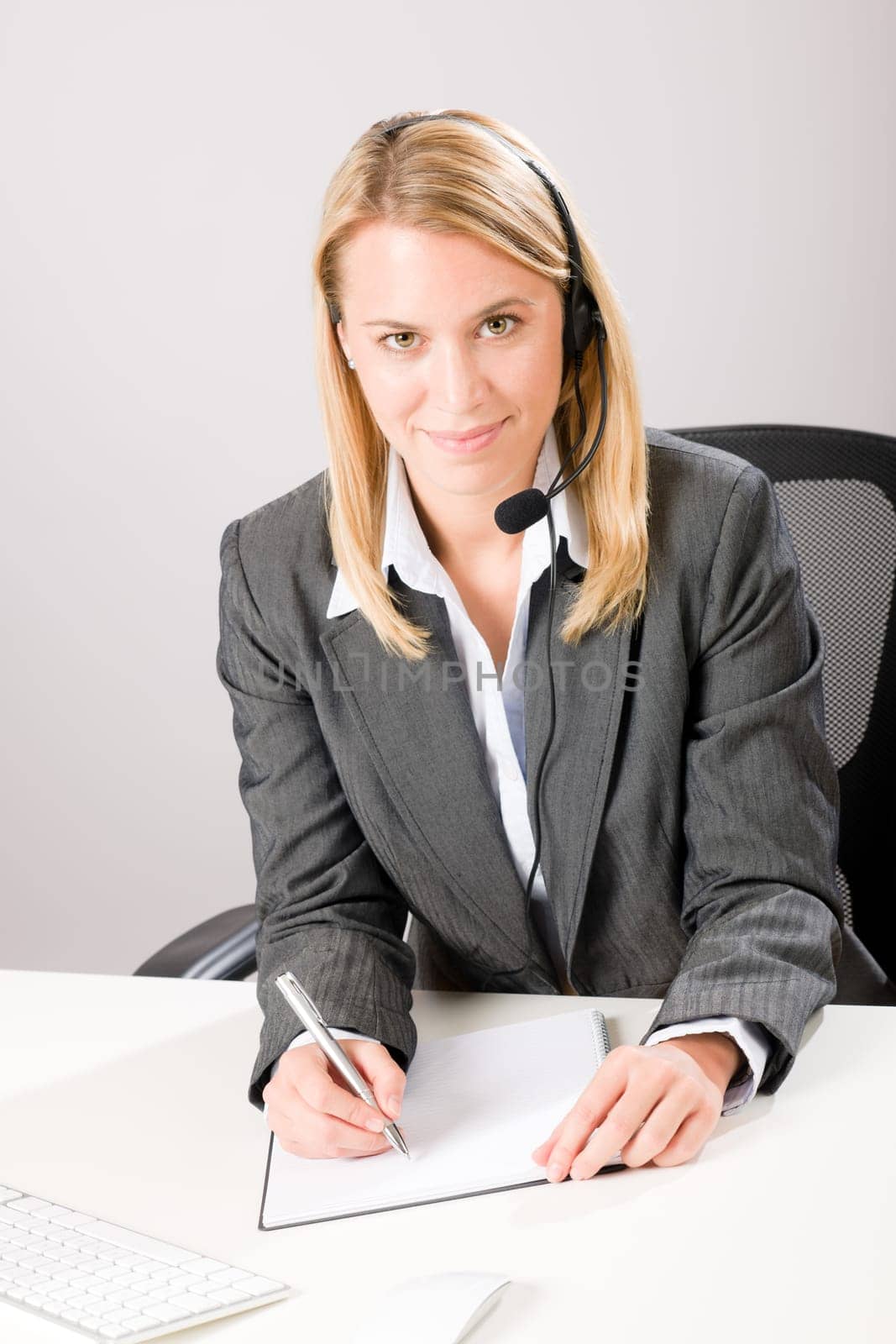 Customer service woman call operator phone headset sitting behind desk
