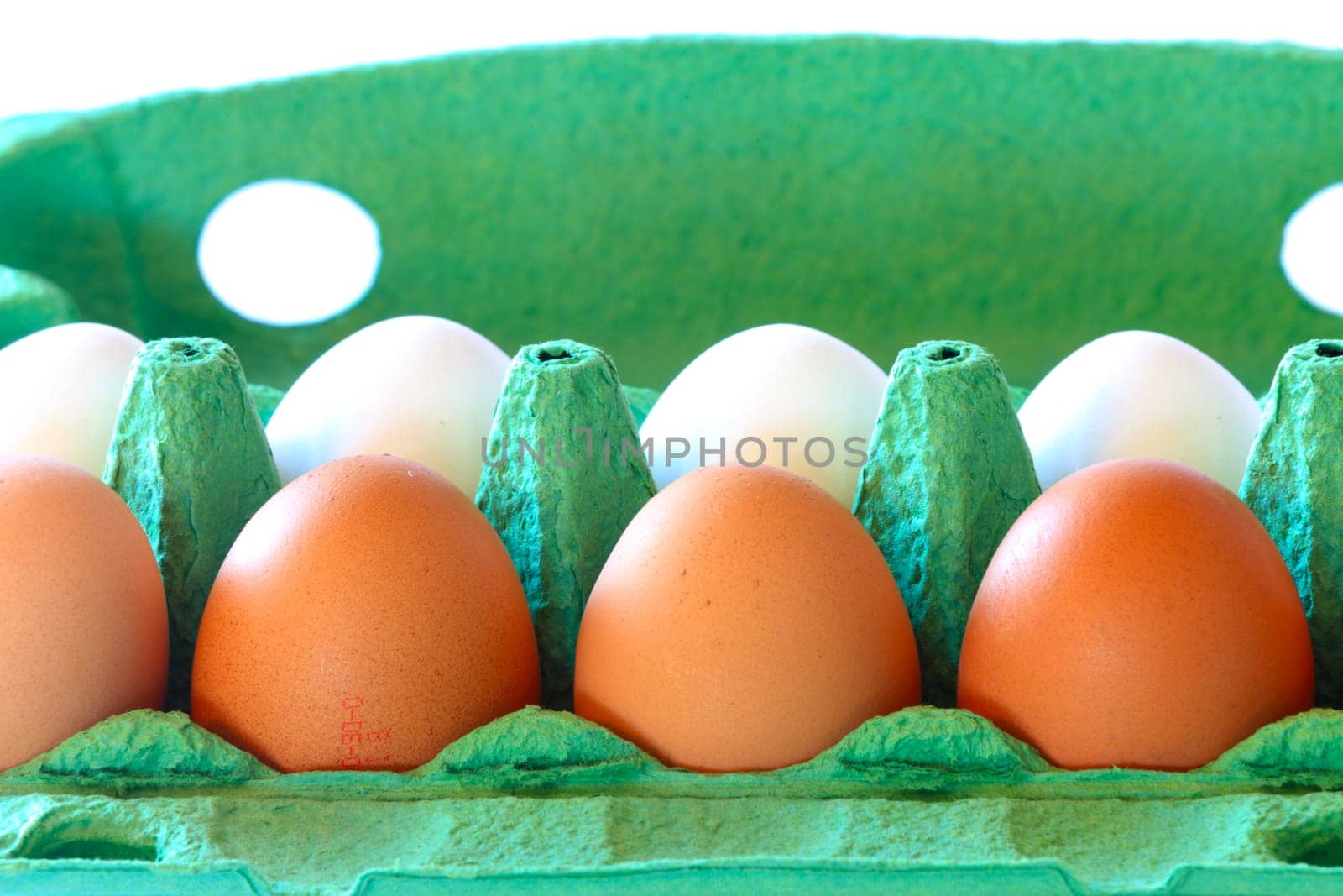 Brown and white chicken eggs in a carton