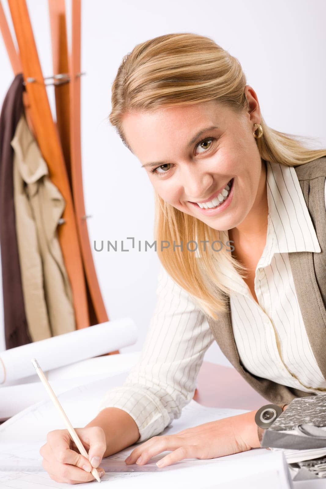 Female architect attractive working on a blueprint sketches in office