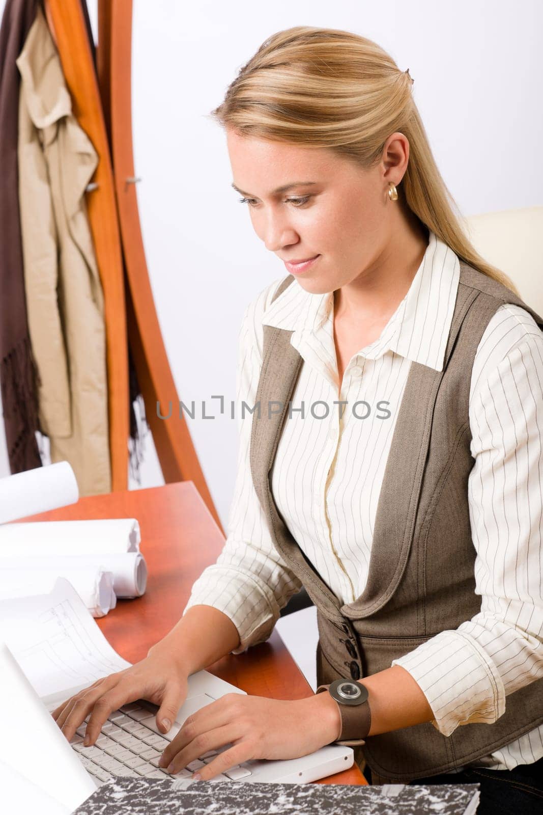 Female architect attractive working on a blueprint sketches in office