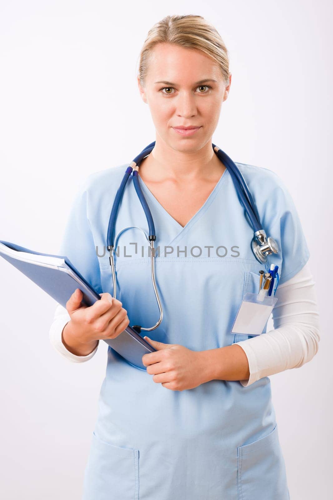 Attractive female doctor standing with stethoscope and folders isolated portrait