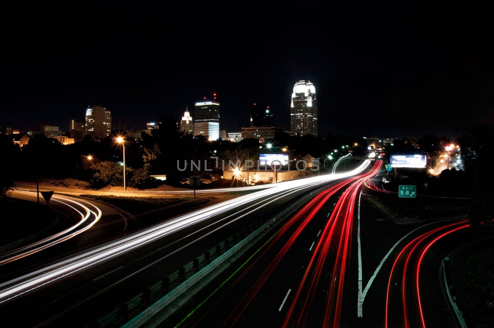 view of interstate 40 and downtown winston salem, north carolina, skyline at night, light trails to portray motion