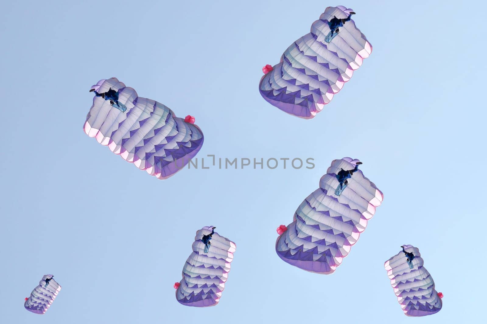 Many parachutes over a blue sky background