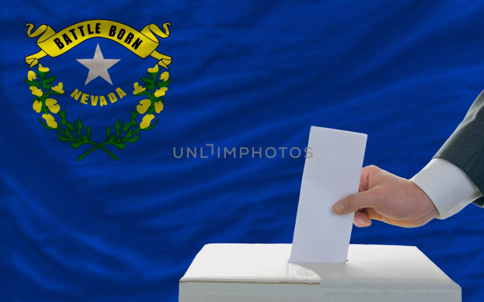man putting ballot in a box during elections  in front of flag american state of nevada