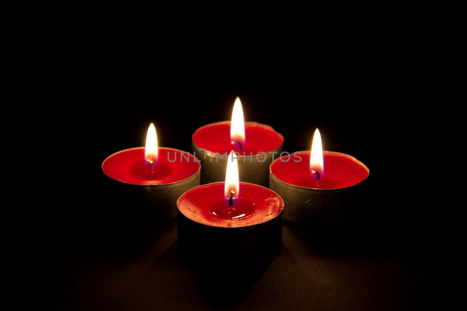 Four flaming red candles