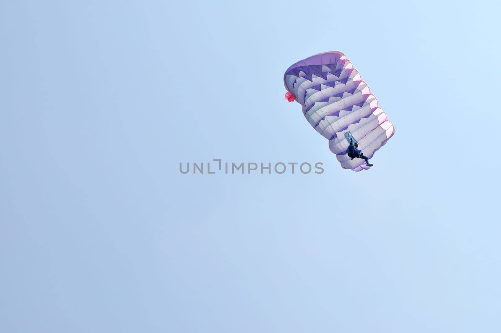 A parachute over a blue sky background