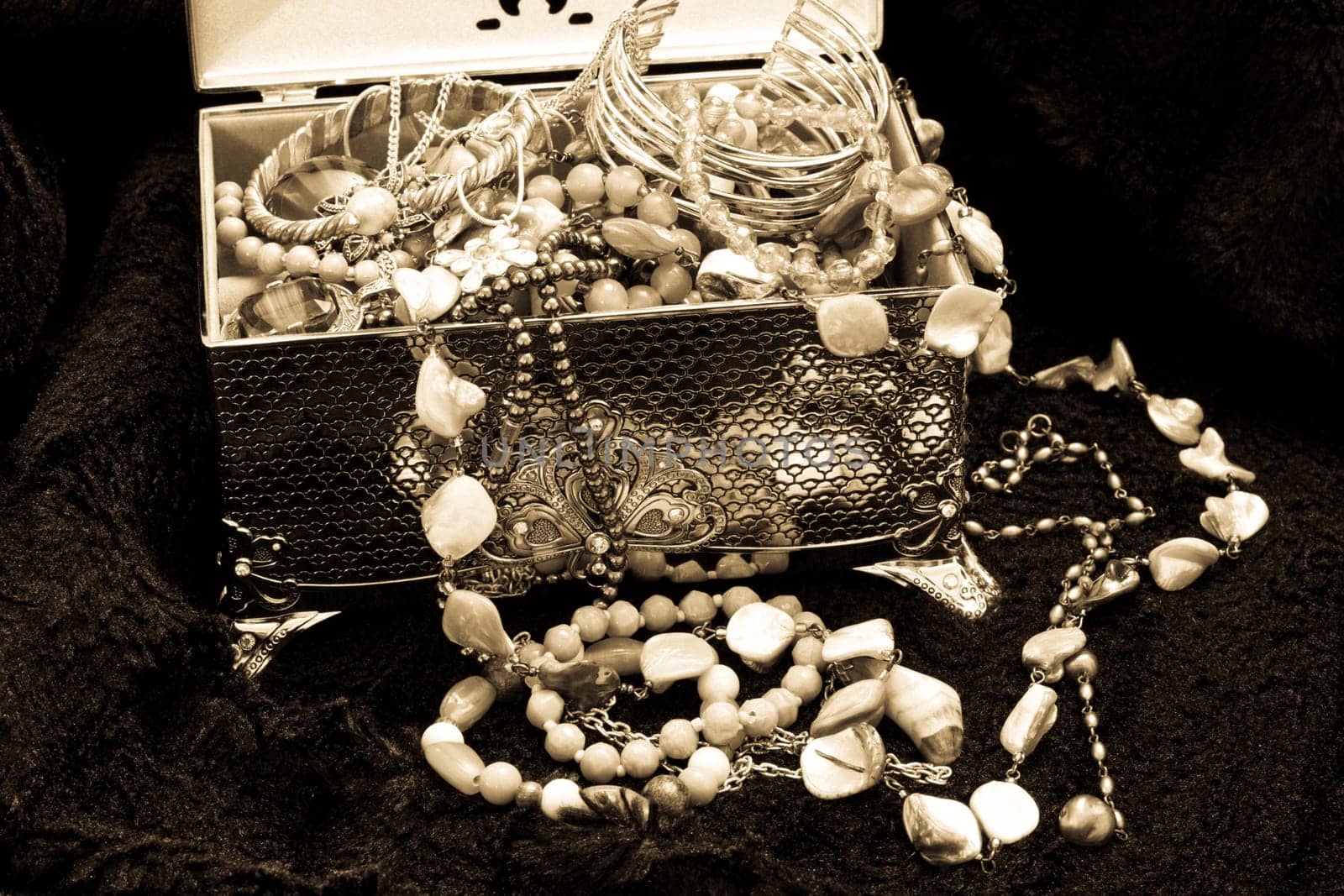 Black and white image of a silver box and jewellry