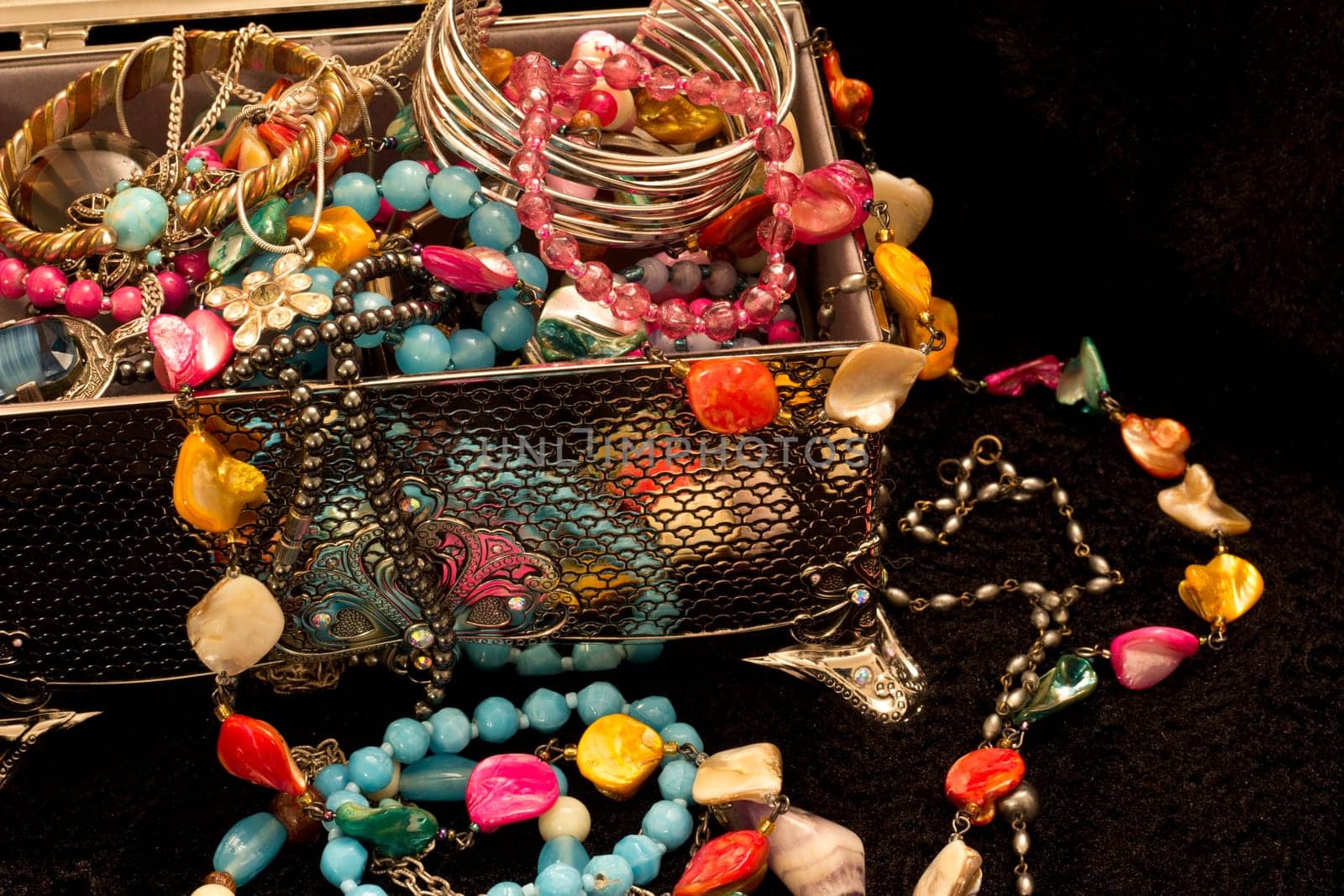 Assorted jewellry spilling from a silver box