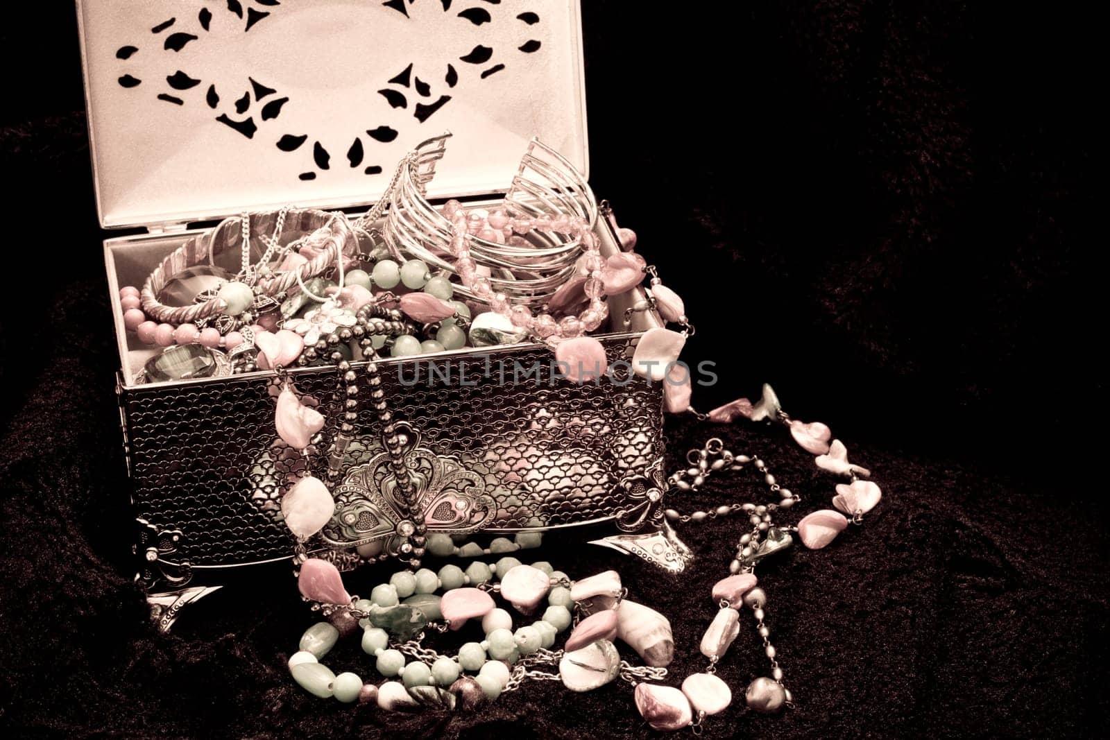 Antique looking jewellry in a silver box on a black fur