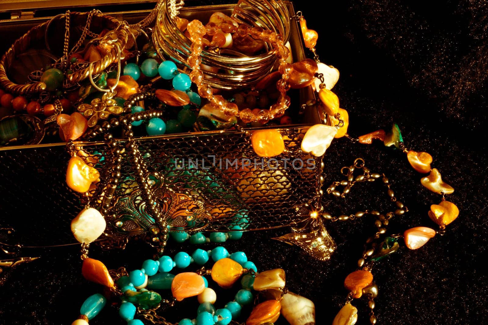 Old looking jewellry in a silver box on a black fur