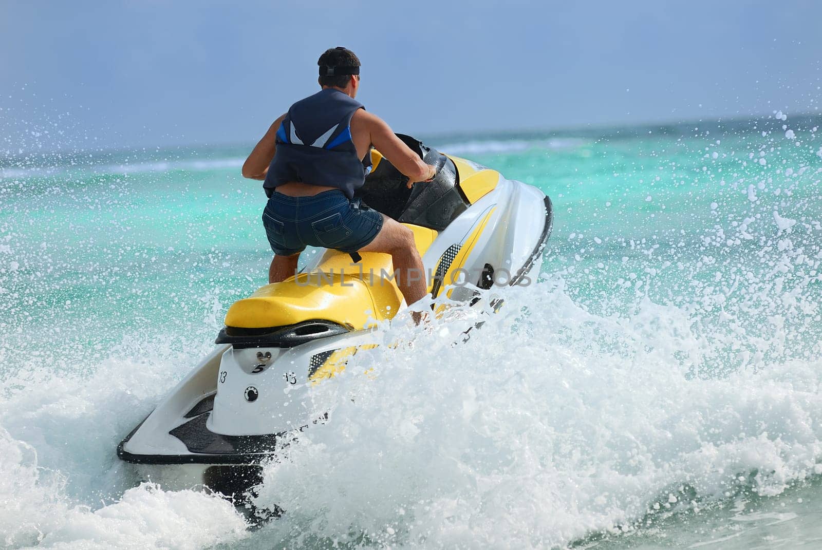 Man on Wave Runner turns fast on the water