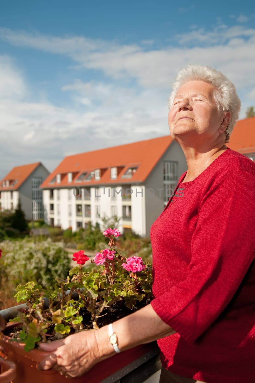 Senior woman sunbathing on the balcony
