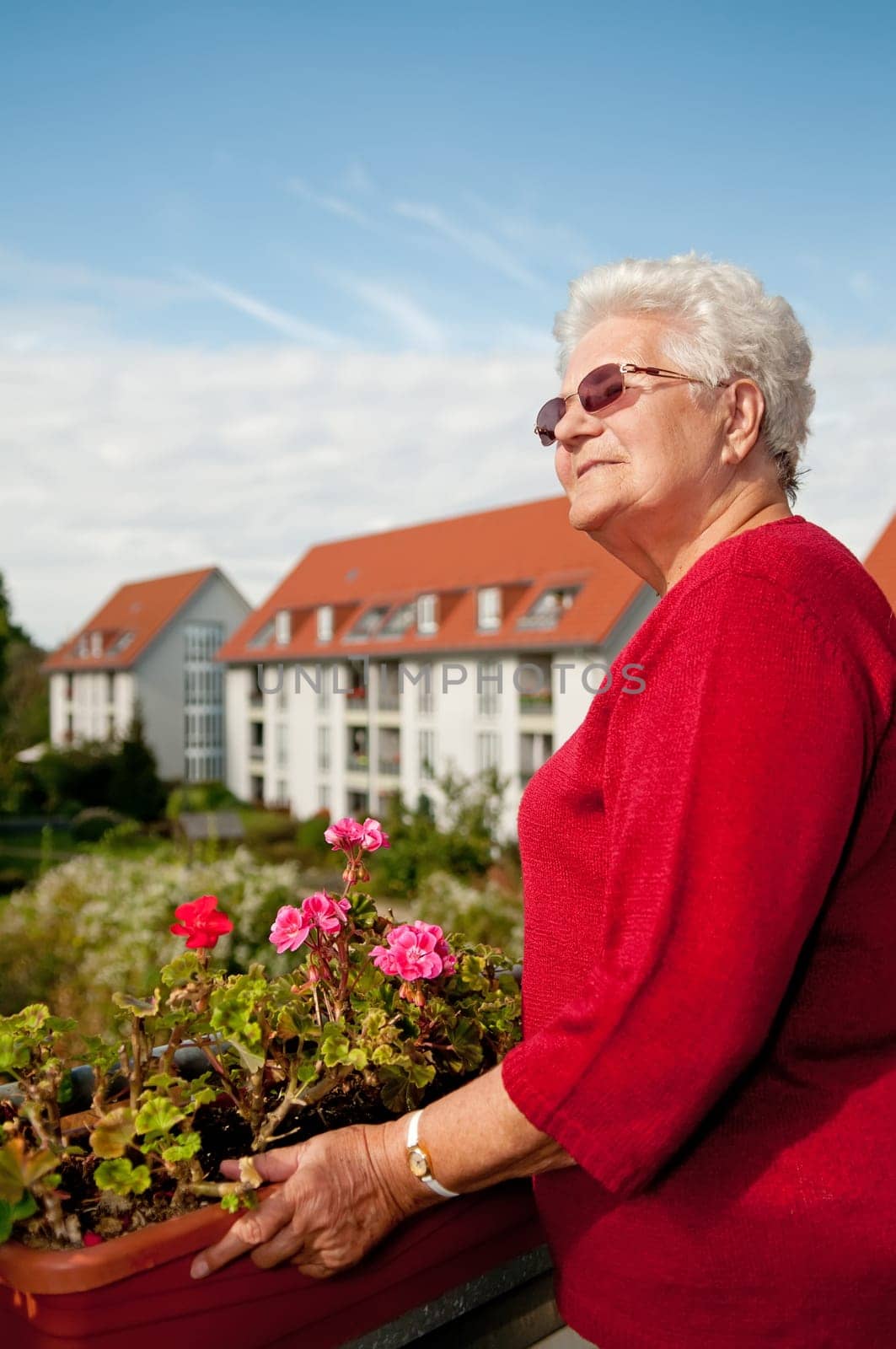 Senior woman sunbathing on the balcony