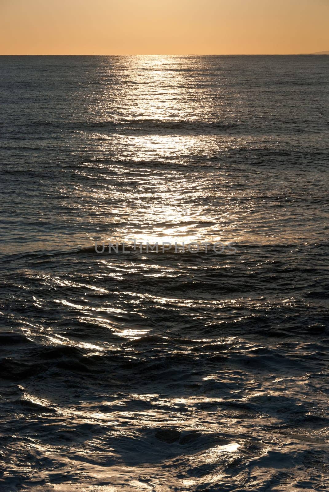 reflections on the waves of the sea at sunset