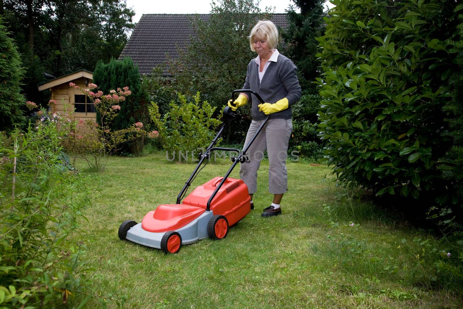 Senior citizen mows lawn