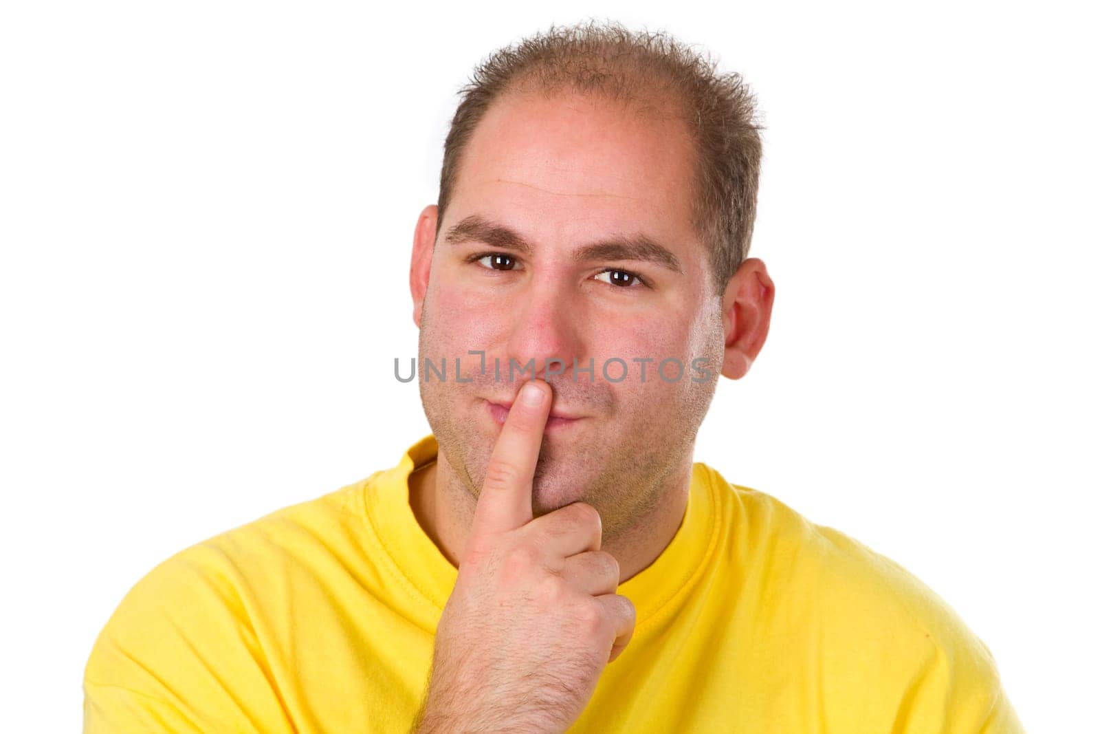 Young man puts his finger on his mouth . Isolated on white background