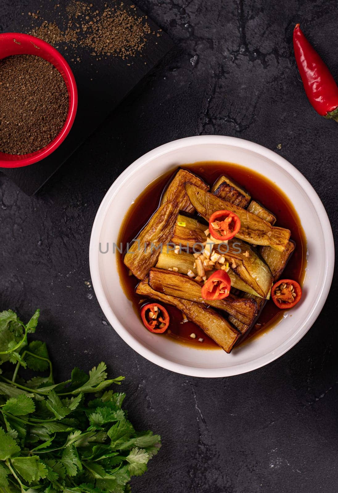 fried eggplant in soy sauce with garlic side view by tewolf