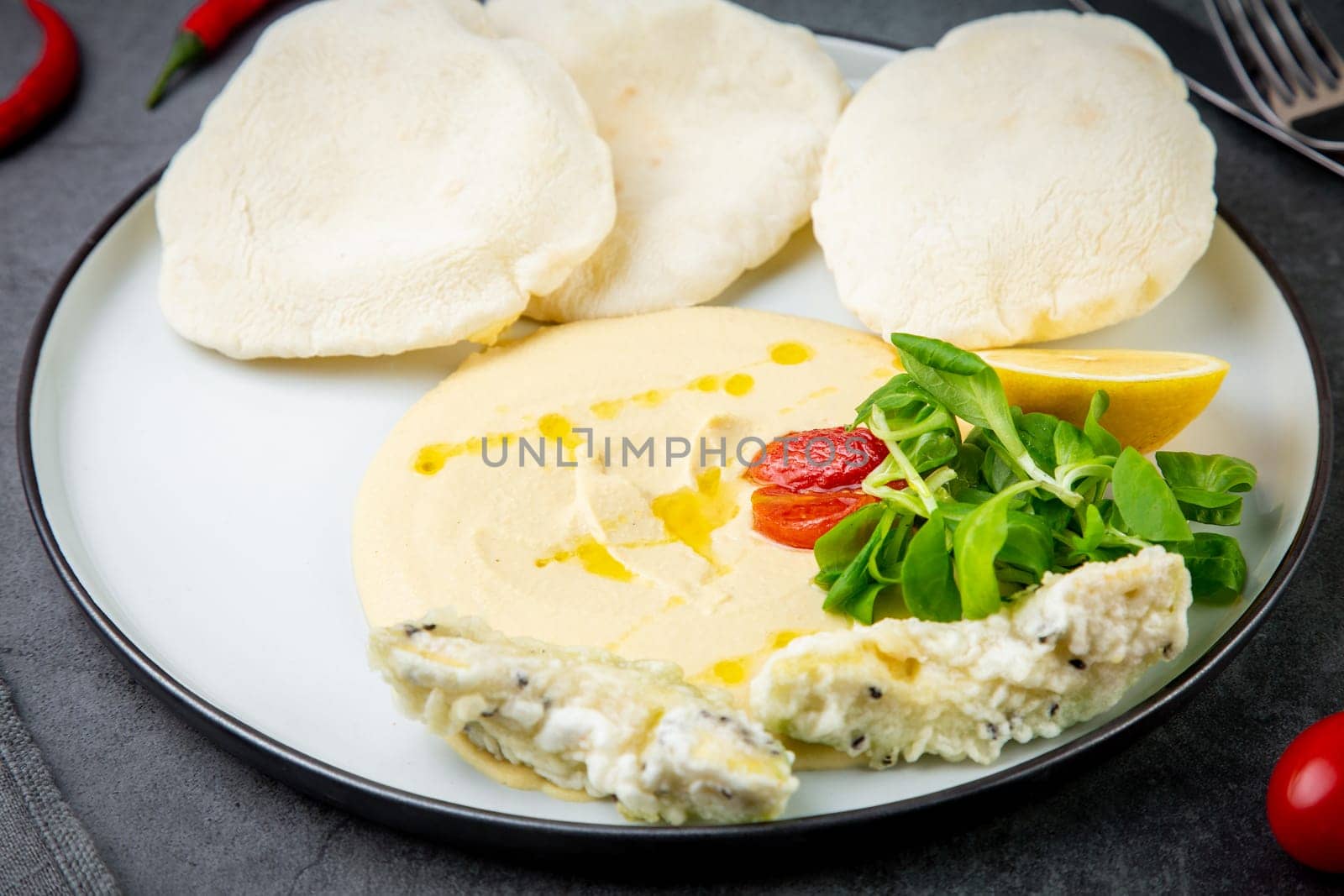 fish steak with rice cakes, cherry tomatoes, lemon and herbs